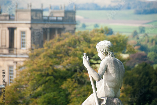 Statue Overlooking Stately Garden