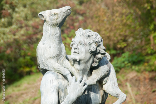 Stone Sculpture of Man Carrying Deer