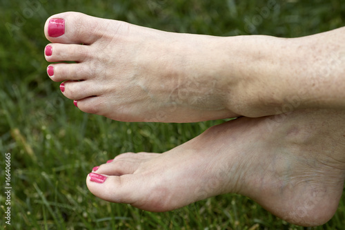 Middle aged Woman's barefeet in the grass © Pamela Au