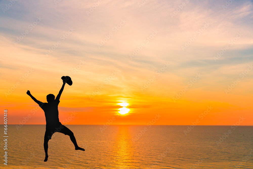 silhouette of man jump on the beach with sunset sea background silhouette of man jump on the beach with sunset sea background