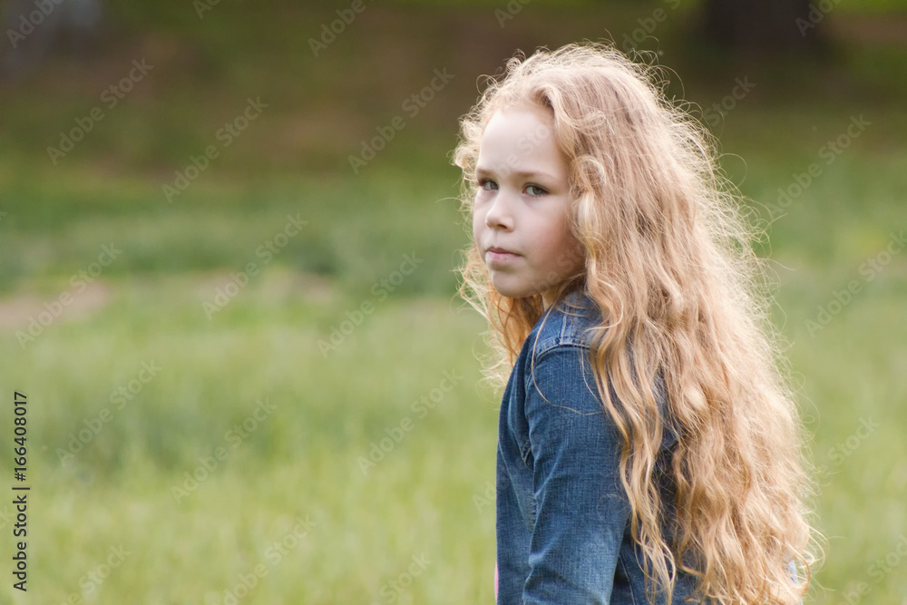 Little girl with curly hair feeling sadness - outdoor portrait Little girl with curly hair feeling sadness - outdoor portrait