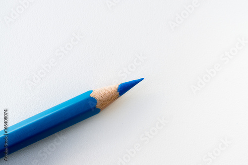 Blue color pencil isolated on white background. Close up.