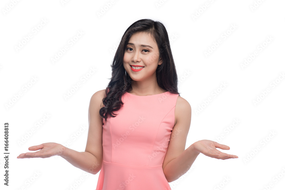 Portrait of a pretty young asian woman gesturing do not know sign isolated on grey Portrait of a pretty young asian woman gesturing do not know sign isolated on grey