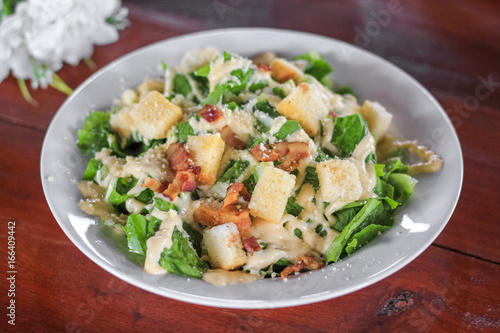 Fresh healthy caesar salad on wooden table