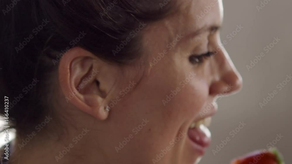 Happy woman eating strawberry, close up, shot on R3D Happy woman eating strawberry, close up, shot on R3D
