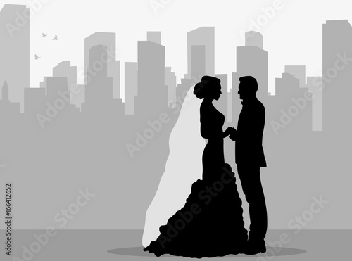 silhouette of the bride and groom on the city background