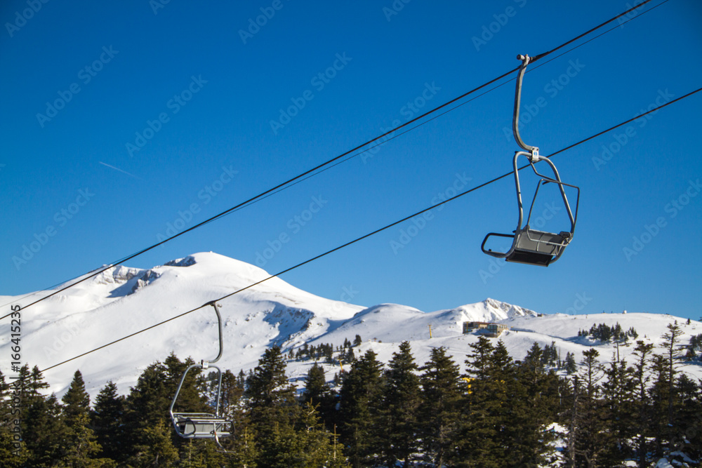 Skiers and snowboarders on a ski lift