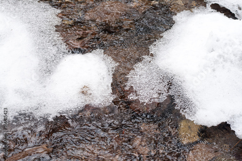 ice formation above a flowing creek © MBAYSAN