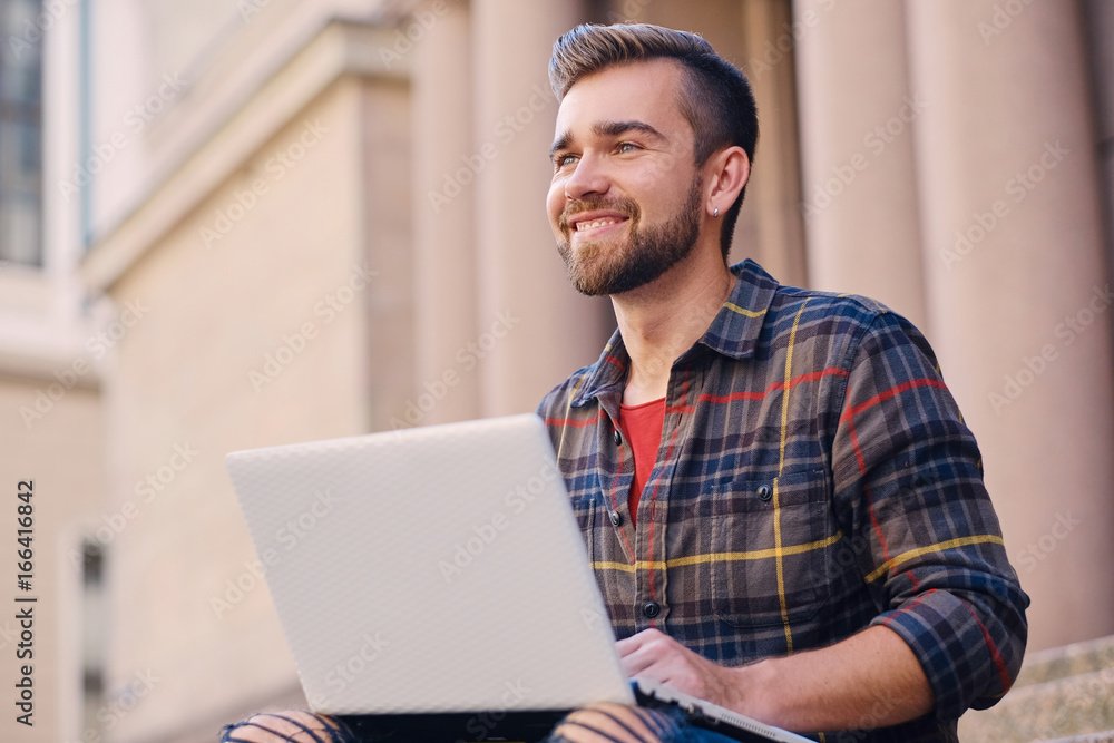 A man using a laptop. A man using a laptop.