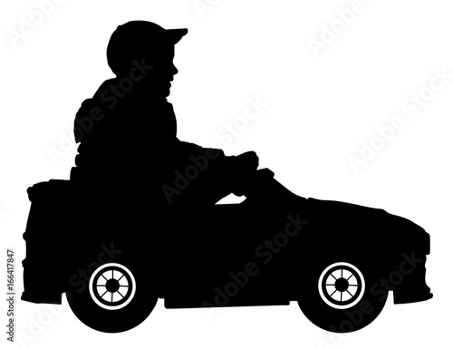 Little boy in a children's electric car silhouette, child is sitting on a baby car