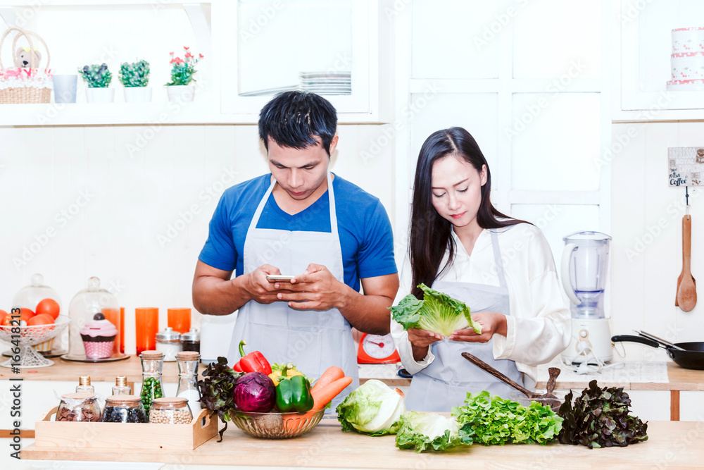 Young couple cooking food in the kitchen Young couple cooking food in the kitchen