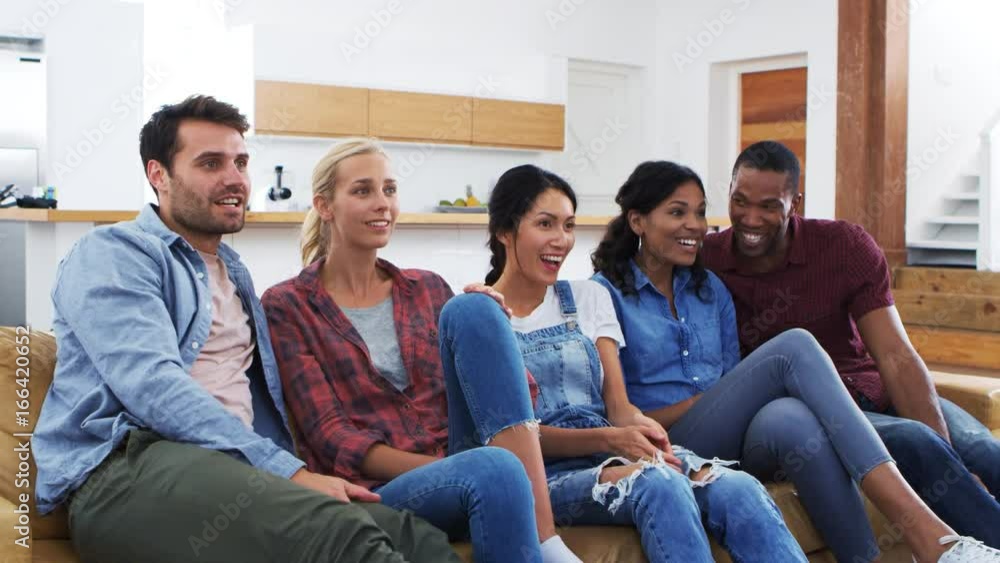 Group Of Young Friends Watching Sports On Television And Cheering Group Of Young Friends Watching Sports On Television And Cheering