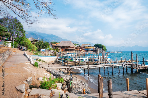 The small village of Panajachel on the shore of  Lake Atitlan in Guatemala. Tourist boats at the docks are used for the tour of the lake. photo