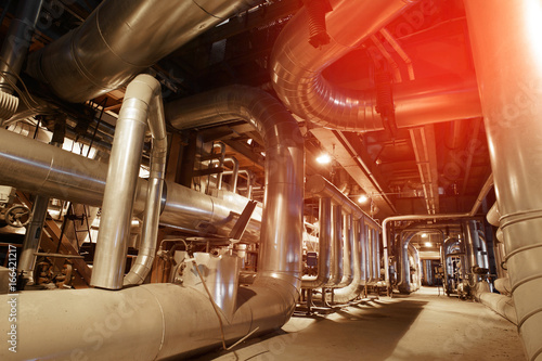 Equipment, cables and piping as found inside of a modern industrial power plant