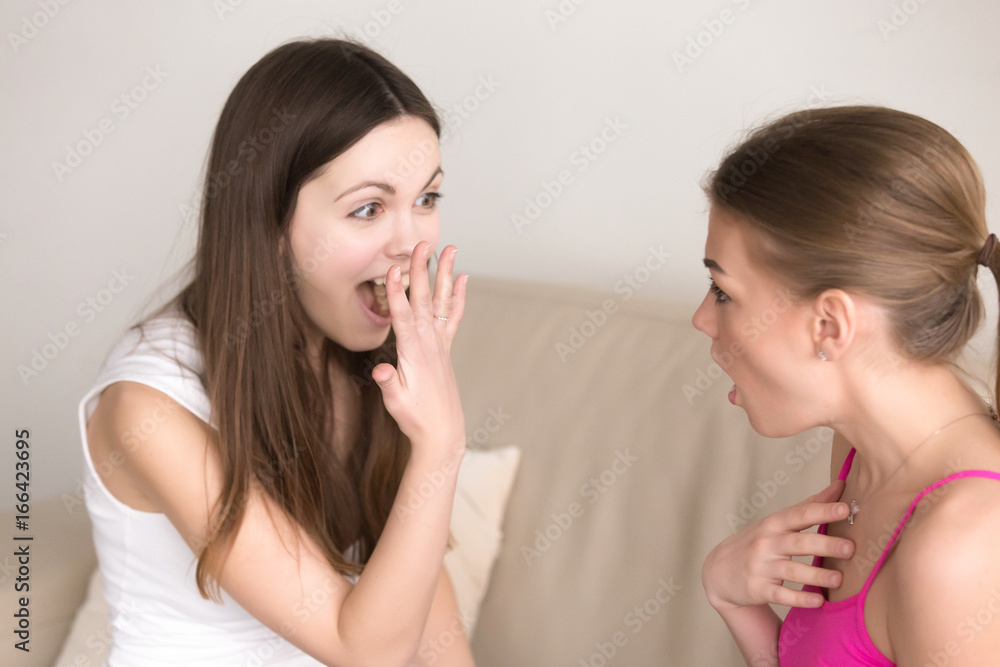 Exited woman showing engagement ring to her close girlfriend who feeling astonished because of unexpected surprise. Happy attractive lady boasting about getting new precious expensive ring on finger Exited woman showing engagement ring to her close girlfriend who feeling astonished because of unexpected surprise. Happy attractive lady boasting about getting new precious expensive ring on finger
