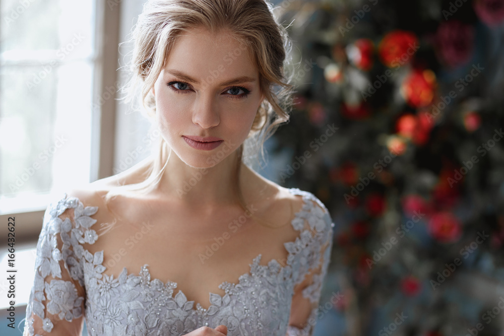 Young blonde bride woman in a light blue wedding dress, fashion beauty portrait in interior Young blonde bride woman in a light blue wedding dress, fashion beauty portrait in interior