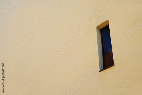  narrow window in the wall of an old house   © sergeevspb