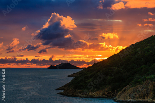 Fototapeta Naklejka Na Ścianę i Meble -  Dramatic Sunset Beyond Tropical Island