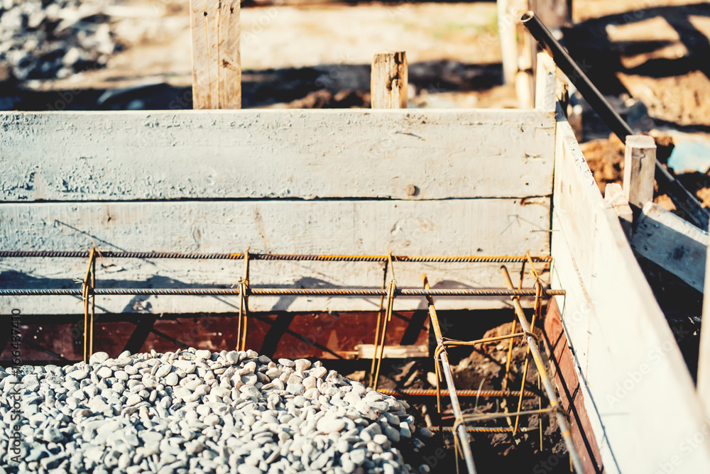 Foundation site of house or building, details and reinforcements with steel bars and wire rod, preparing for cement pouring. Foundation site of house or building, details and reinforcements with steel bars and wire rod, preparing for cement pouring.