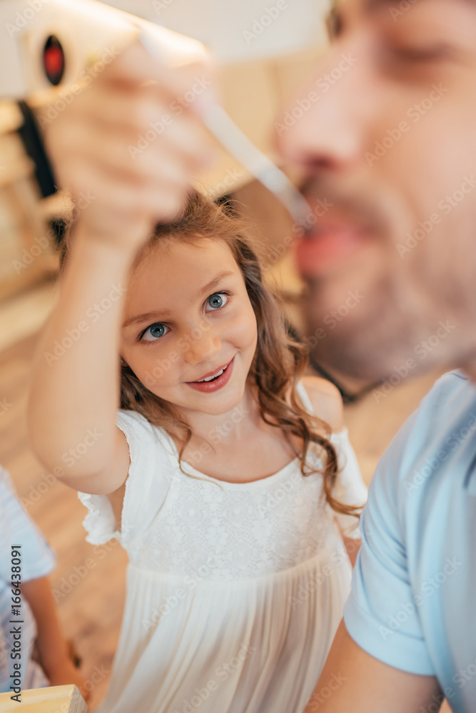little girl feeding her father little girl feeding her father