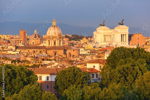 Panoramic aerial wonderful view of Rome with Altar of the Fatherland and churches at sunset time in Rome, Italy