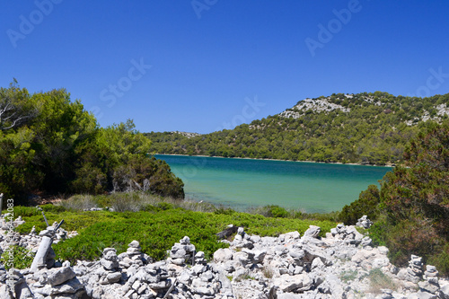 Piles of stones in Telascica Nature Park and lake Mir in the backgrounds, Dalmatia, Croatia