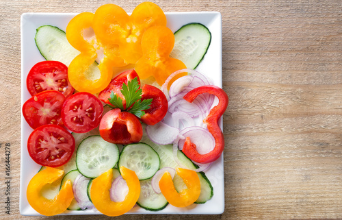 Fresh sliced vegetable salad on a white plate