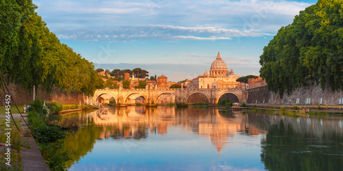 Canvas Print Panorama of Saint Angel bridge and Saint Peter Cathedral with a mirror reflection in the Tiber River in the sunny morning in Rome, Italy
