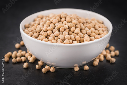 Rustic slate slab with dried Chickpeas, selective focus