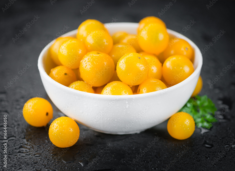 Some Yellow Tomatoes on a dark slate slab Some Yellow Tomatoes on a dark slate slab