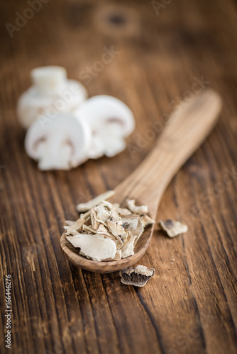 Wooden table with Dried white Mushrooms, selective focus