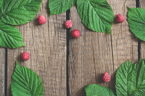 Old village boards Summer background with raspberry and leaves. flat lay with copy space