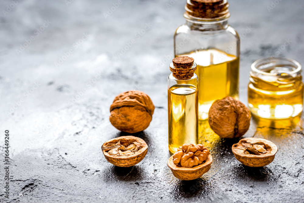 cosmetic and therapeutic walnut oil on dark background cosmetic and therapeutic walnut oil on dark background