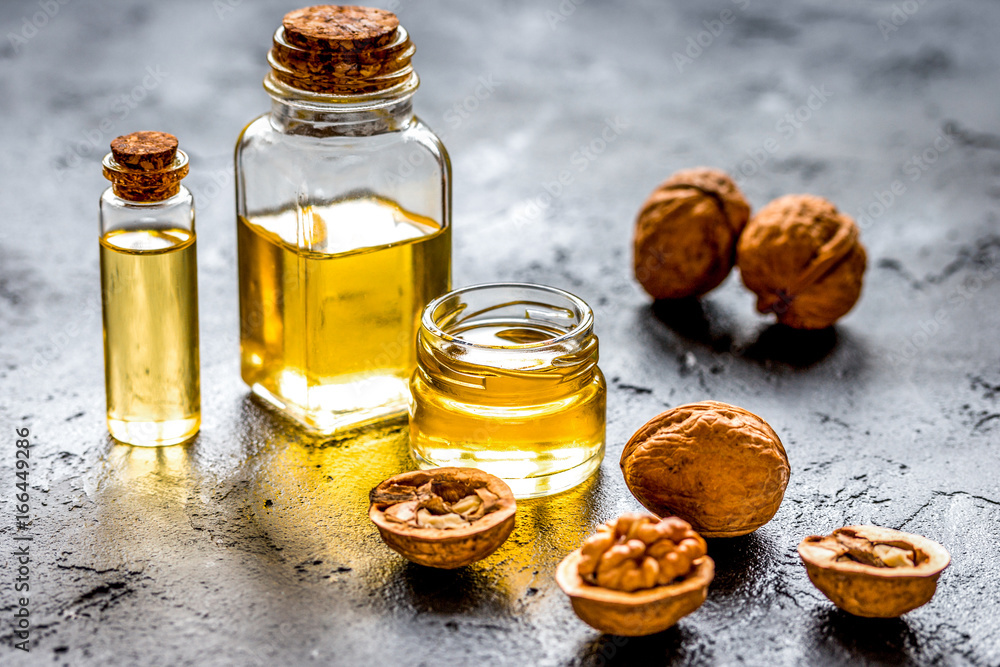 cosmetic and therapeutic walnut oil on dark background cosmetic and therapeutic walnut oil on dark background