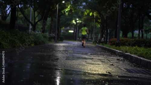 Wallpaper Mural Taipei, Taiwan-29 July, 2017: 4K Runners running man jogging while it rains in Daan park at Taipei city . Exercising Asian People Run In Raining Day, living healthy active lifestyle in Taiwan-Dan Torontodigital.ca