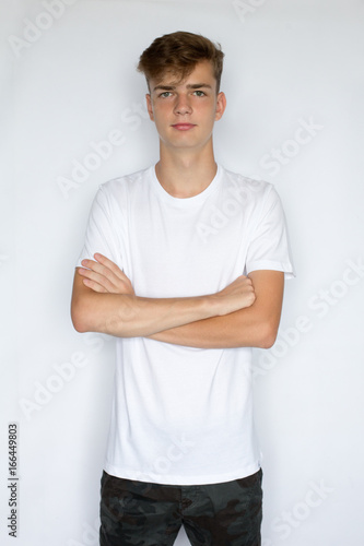 Happy young man in white t-shirt on white background