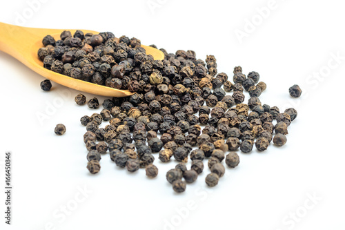 Peppercorn with wooden spoon on white background. Composition isolated over the white background.