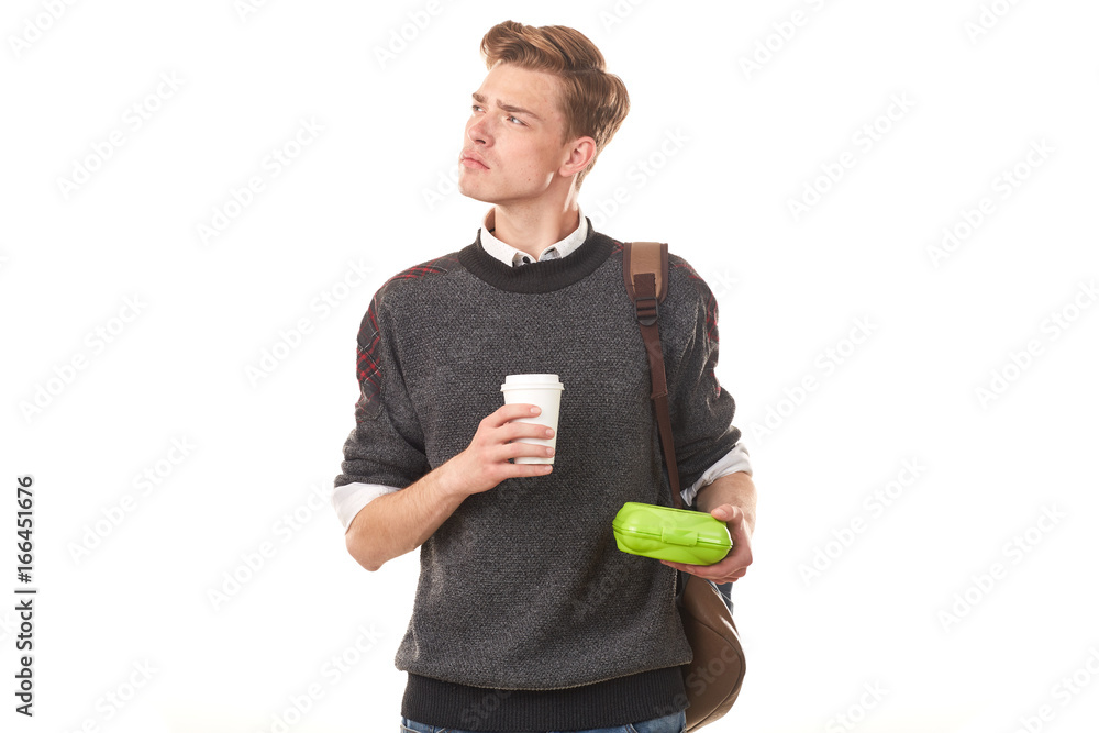Handsome college boy holding lunchbox and paper cup of coffee Handsome college boy holding lunchbox and paper cup of coffee