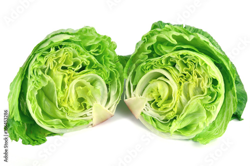 Slice a head of lettuce in half  on white background.
