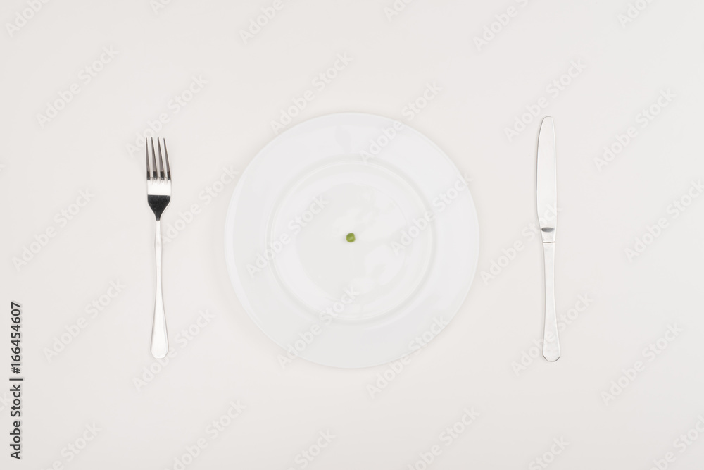 pea on plate, cutlery