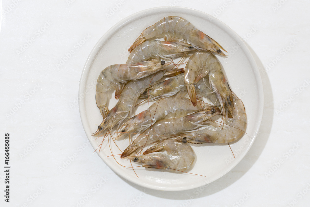 Raw shrimp in a plate isolated on the white backgorund. Raw shrimp in a plate isolated on the white backgorund.