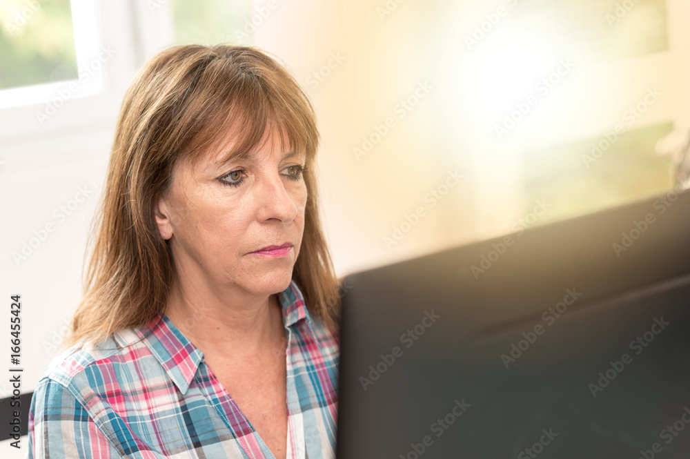 Woman working on computer, light effect Woman working on computer, light effect