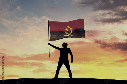 Male silhouette figure waving Angola flag. 3D Rendering photo
