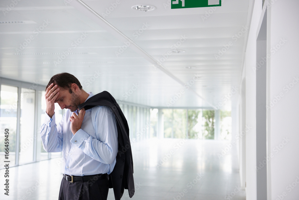 Stressed businessman in an empty office Stressed businessman in an empty office