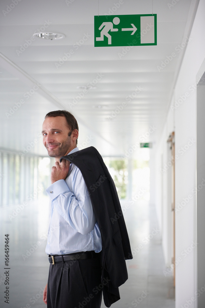 Fototapeta premium Businessman in an empty office, smiling