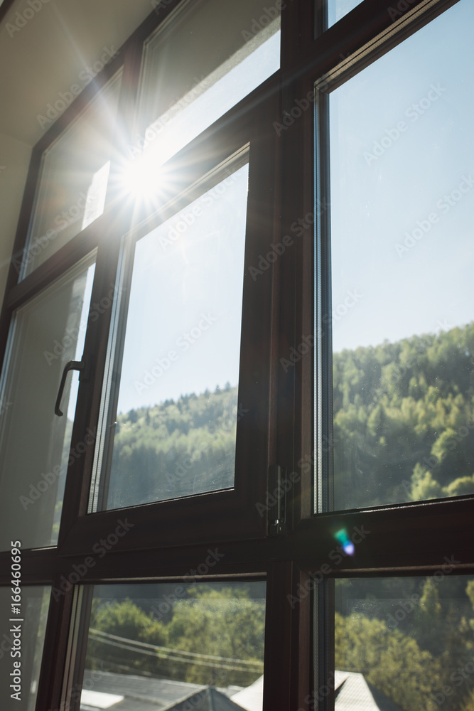 Fototapeta premium Morning in the mountains. Sun shines through the window