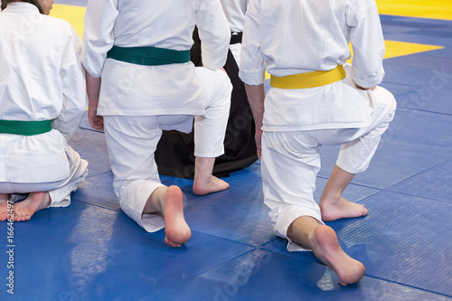 Children in kimono on martial arts training seminar. Selective focus