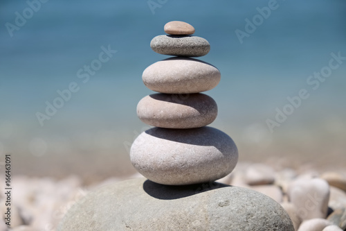 stack of pebbles balance harmony zen - ocean or sea shore, refreshing blue waves summer, beach