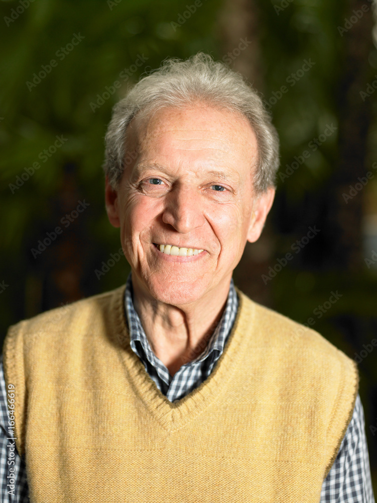 Senior Adult man in front of greenery Senior Adult man in front of greenery