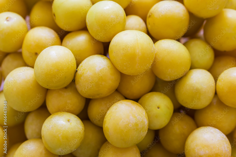 Close up of a bunch of ripe yellow plums. Concept Healthy Eating. Close up of a bunch of ripe yellow plums. Concept Healthy Eating.